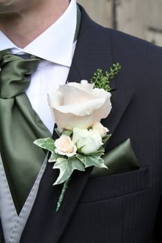 a man in a suit with a boutonniere on his lapel