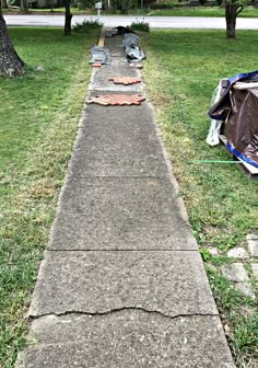 there is a sidewalk that has been laid out in the grass with tarps on it