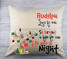 a christmas pillow with reindeer on it and the words rudolph loves his nose, sebrit is helps him read if he looks at night