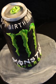 a birthday cake made to look like a monster can with the words happy birthday written on it