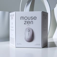 a box with a mouse in it sitting on a table next to a white object