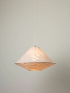 a light fixture hanging from a ceiling in a room with white walls and flooring