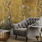 a living room filled with furniture next to a wall covered in gold and green trees