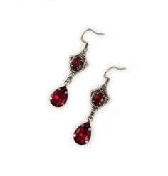 These dainty and elegantly ornate earrings are made with antique silver plated centerpieces, and silver tone settings, worn with stainless steel earring hooks. They are accented with deep ruby red glass crystals/jewels. Earrings measure 2 1/8" in length (including earring hooks) and 1/2" wide. More colors are available in our shop, along with matching chokers.If you don't see items with a color you want, feel free to ask about availability. Red Silver Jewelry, Dark Red Jewelry, Ornate Earrings, Dark Red Earrings, Medieval Steampunk, Gothic Antique, Ornate Necklace, Victorian Wedding, Choker Pendant