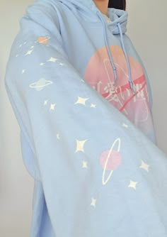 "\"Kawaii Sekai\" which translates to \"Cute World\" is a Harajuku & NASA inspired design, with both sleeves printed with pastel colored planets and stars. If space was pink, and planets were filled with cute things, would you like to visit? ('* ω  ♡ Printed via Direct-to-Garment method for a matte finish that blends well with the fabric without excess edges. American sizing! Size chart on the last image. ❤ 50% pre-shrunk cotton, 50% polyester ❤ Air-jet spun yarn with a soft feel and reduced pil Kawaii Blue Cotton Hoodie, Blue Cotton Kawaii Hoodie, Blue Harajuku Cotton Sweatshirt, Blue Cotton Harajuku Sweatshirt, Cute Blue Hoodie With Cartoon Print, Blue Long Sleeve Kawaii Sweatshirt, Cute Blue Crew Neck Hoodie, Pastel Outfits Aesthetic, Cute Pastel Outfits