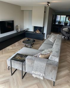 a living room filled with furniture and a flat screen tv mounted to the side of a wall