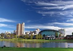 a lake in front of a city with tall buildings