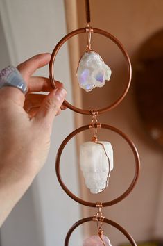 This gemstone Chakra hanging is not only uplifting and radiant, it's made using crystals that vibrate at a high level and have Rose Quartz, the Love Stone, anchoring this magical piece in love. Place this in a room where you spend time with loved ones or you spend time loving on yourself with self care, journaling and meditation. 3 gemstones hand-wrapped in copper set in 4" metal rings Gemstones from top down: Angel Aura Quartz, Selenite tower, & Rose Quartz Add optional quartz point to bottom as shown in images Quartz point is approximately 2.75" to 3" long Chakra hanging length is 1 foot 3" not including optional bottom quartz 20" hanging cord available in black, white & brown leather or black vegan Handmade in Arizona Not eligible for exchanges, returns or discounts.We try to match the Selenite Tower, Using Crystals, Chakra Gifts, Angel Aura Quartz, Angel Aura, Crystal Suncatchers, Crystal Accessories, Black Vegan, Mala Necklace