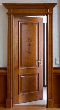 an open wooden door in the middle of a room