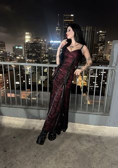 This fully lined maxi dress has a satin construction with a lace overlay, a front lace-up ribbon design, grommet detailing, ruffled tulle trim on the bust, adjustable shoulder straps, and a back zipper closure. Vampire Goth, Halloween Items, Ribbon Design, Halloween Sale, Lace Ribbon, Red Mini Dress, Coven, Lace Overlay, Gothic Fashion