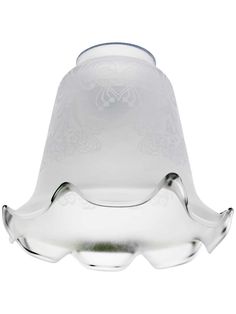 a glass light that is on top of a white tablecloths and the bottom has an ornate design