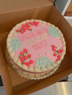 a pink birthday cake in a box with the words happy birthday to you on it