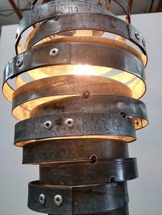 an industrial style light fixture made out of metal strips and steel rings with lights on each end