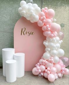 balloons and candles are on the floor next to a pink sign that says rosie