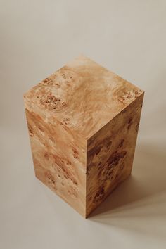 a wooden block sitting on top of a white surface