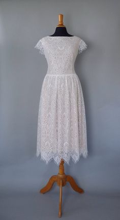 a white lace dress on a mannequin