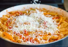 the pasta dish is topped with parmesan cheese and tomato sauce, ready to be eaten