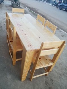 a wooden table and chairs sitting on the ground