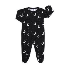 a baby sleepsuit with the moon and stars printed on it, in black cotton