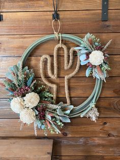 a wreath with flowers hanging on the wall