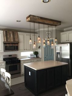 a kitchen with an island, stove and refrigerator