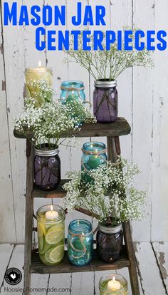 several jars with flowers and candles on a shelf