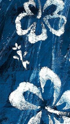 an abstract painting with white flowers on blue background