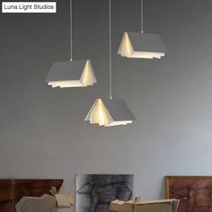 three lights hanging from the ceiling in a room