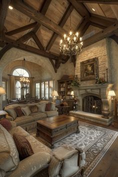 a living room filled with lots of furniture and a chandelier hanging from the ceiling