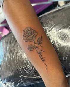 a person with a rose tattoo on their arm