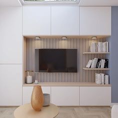 a modern living room with white walls and wood flooring, built - in bookshelves