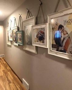 a wall with several pictures hanging on it