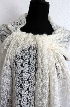 a black and white lace shawl on a mannequin