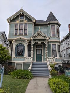 an old victorian style house with blue trim