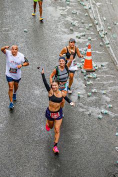 people running in a marathon with bottles on the ground