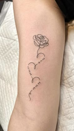 a woman's arm with a rose tattoo on it and the words love written in cursive writing