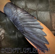 "\"Raven Queen's wing\" - this hand tooled leather winged cuff could become a bright detail of your Halloween / LARP / cosplay costume. Such a stylish noir wing with shiny blue accents wouldn't stay unnoticed ;) The bracelet you see on the pictures was MADE TO ORDER. The wing is ~9\" long and was made to fit the 6 1/2\" wrist. If you'd like me to make something similar for you - just push the \"custom order\" button and I'll design something exclusive in accordance with your measurements and col Wing Cosplay, Rustic Cuff Bracelets, Leather Gifts For Her, Raven Wings, Leather Bracers, Hand Painted Leather, Hand Tooled Leather, Painting Leather, Tooled Leather