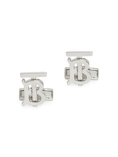 two silver cufflinks with initials on them