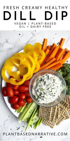 fresh creamy healthy dill dip with veggies and crackers on the side