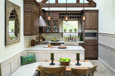 a kitchen filled with lots of wooden cabinets and counter top space next to a breakfast nook