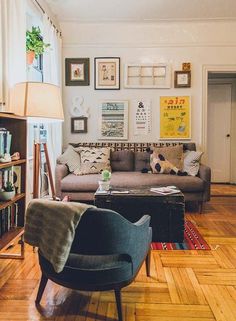 a living room filled with furniture and pictures on the wall