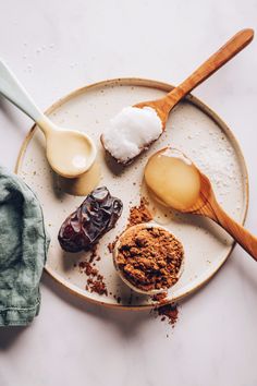 an assortment of desserts on a plate with spoons