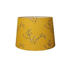 a yellow lamp shade with white flowers on it