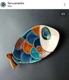 a fish shaped ceramic dish on a table