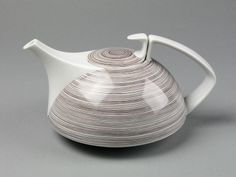 a white tea pot sitting on top of a table