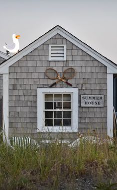 an old building with a sign on the front that says summer house and two magnifying glasses above it