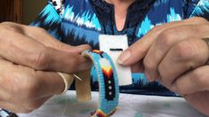 an older woman is making bracelets with fabric