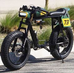 a green and black motorcycle parked on the street