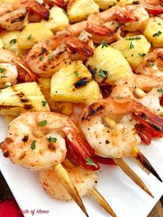 grilled shrimp and pineapple skewers on a white plate