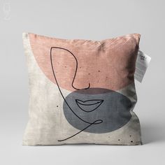 a pillow with an abstract design on the front and back of it, featuring a woman's face